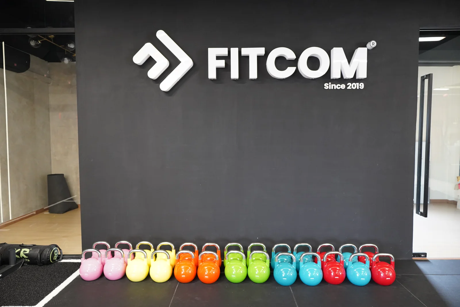 Kettlebells and free weights at the Fitcom Melaka studio